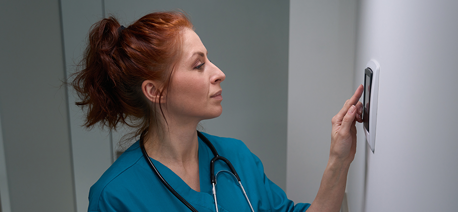 doctor adjusting thermostat